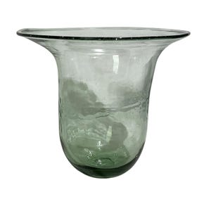 May include: A clear, light green glass vase with a wide, flared rim and a rounded base. The glass features a textured, rippled surface with visible air bubbles throughout the material, creating a translucent appearance with varying green tones.