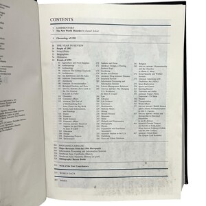 May include: Open book displaying a detailed table of contents. The headings include "Commentary," "The Year in Review," and "Britannica Update." Various topics are listed, such as biographies, health, and the arts.