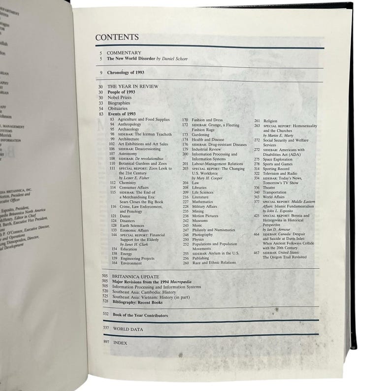 May include: Open book displaying a detailed table of contents. The headings include "Commentary," "The Year in Review," and "Britannica Update." Various topics are listed, such as biographies, health, and the arts.