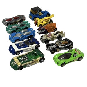 May include: A collection of 10 toy cars, including a blue truck, a yellow car with a flame design, a purple car, a gold car, a black car, a green car, a white car, a blue car, a green car, and a lime green car.