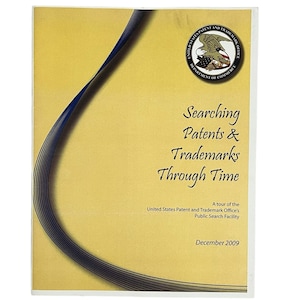 May include: A yellow brochure with a blue curved line design. The brochure has the text "Searching Patents & Trademarks Through Time" and "A tour of the United States Patent and Trademark Office's Public Search Facility". The brochure also has the text "December 2009".