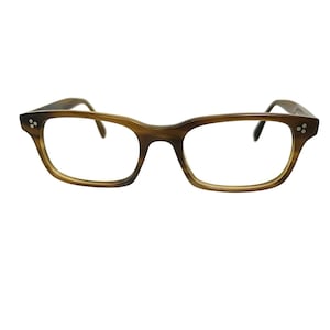 May include: Rectangular eyeglasses featuring a brown and tan horn-rimmed pattern. The frame includes silver-toned metal rivets on each outer corner, with a bridge connecting the two lenses and curved temples extending from the sides of the frame.