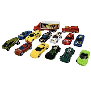 May include: A collection of toy cars in various colors, including red, yellow, green, blue, and black. The set includes a red semi-truck with a McDonald's logo and a red fire truck. The cars are made of die-cast metal and plastic.