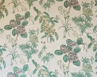 May include: Cream-coloured fabric with a repeating floral pattern. The design features pink and green flowers, along with green foliage and yellow accents. The botanical print is spread across the fabric.