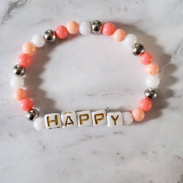 Handmade Unique Bead / Beaded Bracelet with peach and white beads featuring the word HAPPY. Cute Uplifting / Taylor Swift Inspired Bracelet