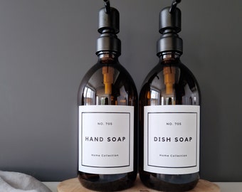 May include: Two amber glass bottles with black pump tops and white labels. The labels read "No. 705 Hand Soap Home Collection" and "No. 705 Dish Soap Home Collection".