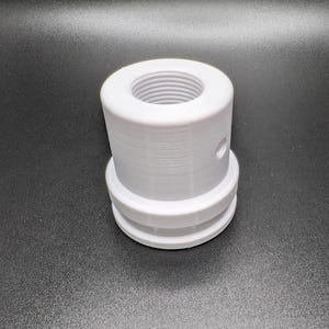 May include: White plastic adapter with a threaded opening and a small hole on the side.