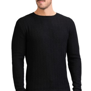 May include: A black long-sleeved sweater with a herringbone pattern.