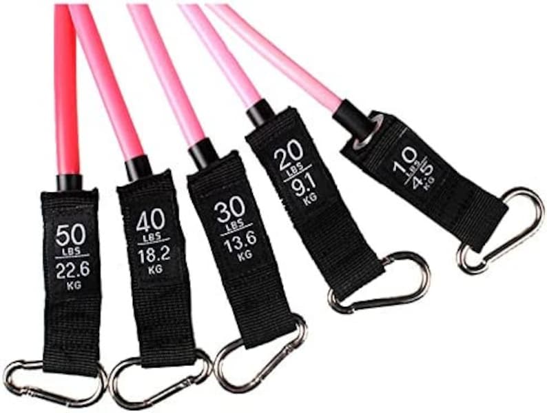 May include: A set of five resistance bands in varying strengths for exercise. The bands are pink and black, with silver carabiner clips. Each band has a black label indicating the resistance in pounds and kilograms, ranging from 10 lbs (4.5 kg) to 50 lbs (22.6 kg).