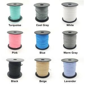 Könnte beinhalten: Neun Spulen Kordel in verschiedenen Farben, darunter Türkis, Cool Grey, Weiß, Pink, Blau, Warm Grey, Schwarz, Beige und Lavendel. Jede Spule ist mit ihrem Farbnamen beschriftet.