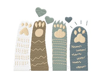 May include: Four embroidered cat paws with different patterns and colours. The paws are arranged vertically and have a heart above each one. The colours are white, brown, blue, and light blue.