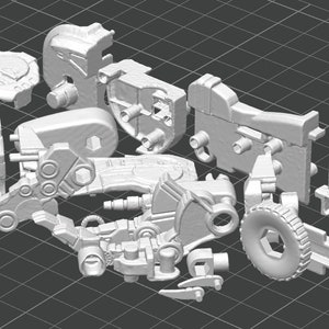 May include: A selection of light grey 3D-printed mechanical components, including gears, joints, and structural elements. The pieces are arranged on a dark grey grid, suggesting a disassembled machine or model kit. The parts vary in size and shape.