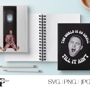 May include: Two black spiral notebooks with white covers. The notebook on the left has a photo of a man in a pink suit sitting in a doorway. The notebook on the right has a black cover with white text that reads "The world is so small till it ain't". The text is in a retro font. A man's face is in the center of the text.