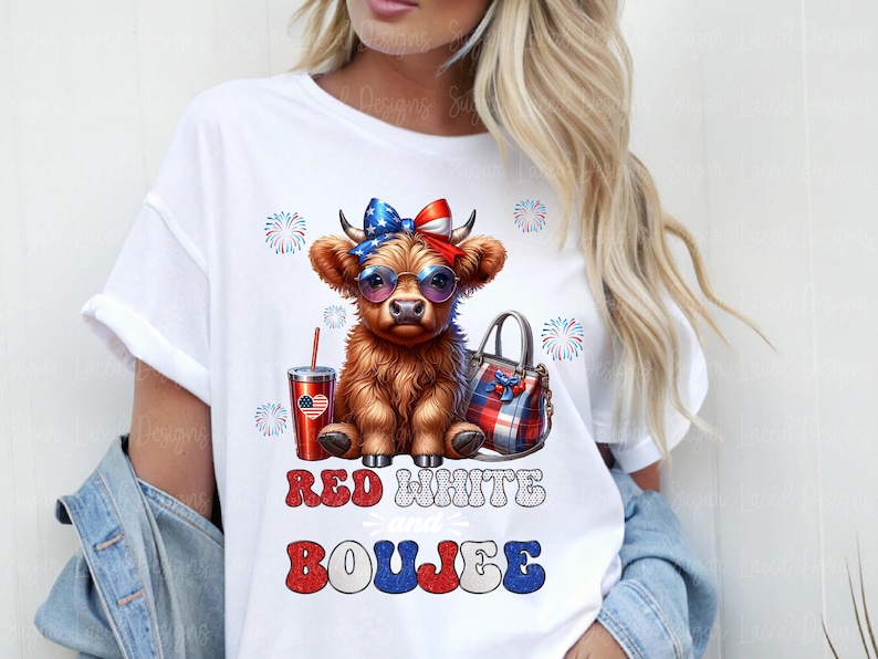 May include: A white t-shirt featuring a graphic of a brown Highland cow wearing a red, white, and blue bow and sunglasses. Beside the cow is a red tumbler and a plaid handbag. The text reads RED WHITE and BOUJEE with firework accents.