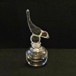 Bird Sitting on a Perfume Bottle