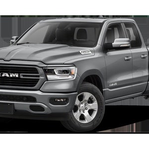 May include: A gray Ram pickup truck with a black grille and the word "RAM" in silver lettering. The truck has a black bumper and black side steps.