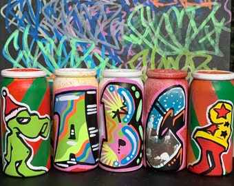 Custom graffiti artwork made on MINI empty spray cans