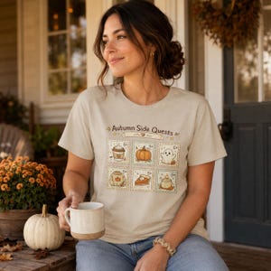 Maglietta autunnale con missioni secondarie, maglietta grafica con zucca fantasma, maglietta accogliente con timbro a tema spettrale per la stagione.
