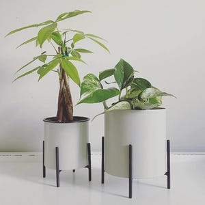 white pot with black metal stand planter set