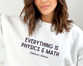 May include: White sweatshirt with the text "Everything is Physics & Math" and the name "Katherine Johnson" written in cursive below.