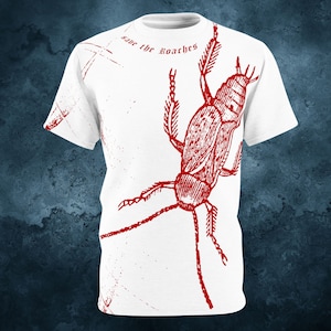 May include: White t-shirt with a red illustration of a cockroach and the text "save the roaches".