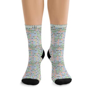 May include: A pair of knee-high socks featuring a colorful genetic code pattern. The socks have a black heel and toe, and the text "180" and "170" are visible at the top. The design includes various colors and sequences.