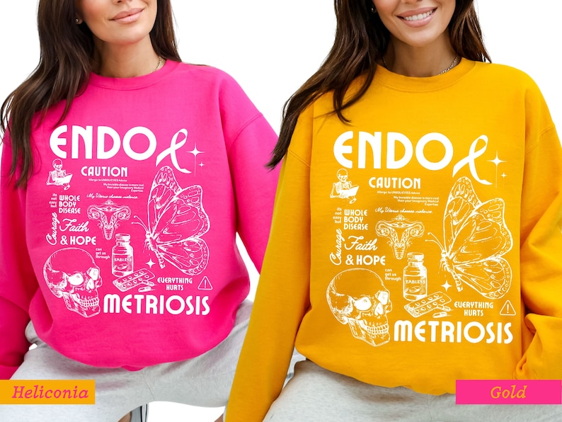 May include: Two pink and gold sweatshirts with a white graphic design. The design features a butterfly, a skull, and the text "ENDO CAUTION EVERYTHING HURTS METRIOSIS".