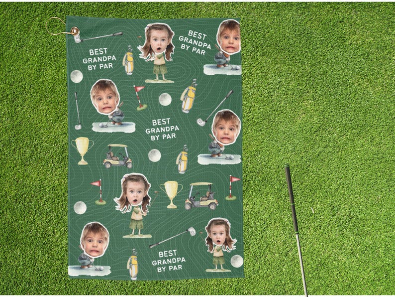 May include: Green golf towel with a repeating pattern of cartoon golfers, golf balls, golf carts, and trophies. The towel has the text "BEST GRANDPA BY PAR" and includes a loop for hanging.