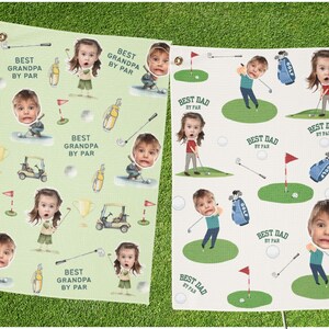 May include: Two golf towels with a repeating pattern of a child's face, golf equipment, and the phrases "Best Grandpa By Par" and "Best Dad By Par". One towel is light green, the other is off-white.