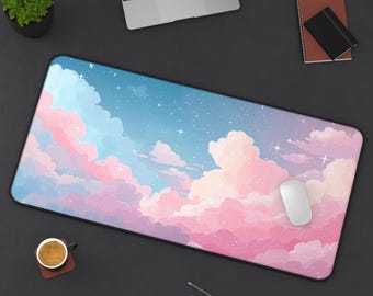 May include: A rectangular desk mouse pad featuring a dreamy sky design with pink and purple clouds against a blue background. A white mouse rests on the pad, with a laptop, coffee cup, and stationery nearby.
