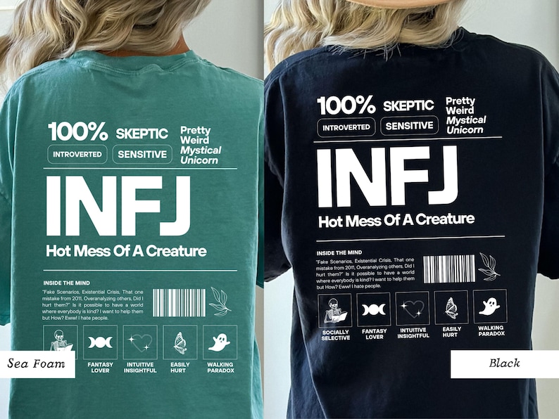 May include: A black and a teal green t-shirt with a white graphic print that says "100% Skeptic" and "INFJ Hot Mess Of A Creature". The graphic also includes a list of personality traits, such as "Introverted", "Sensitive", "Fantasy Lover", and "Intuitive Insightful".