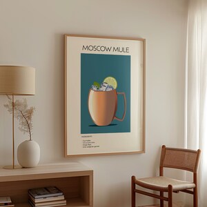 A framed "Moscow Mule" cocktail print hanging in a living room with minimalist furniture and décor, adding a chic and playful element to the space.