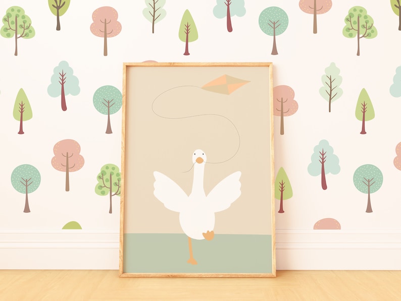 A nursery print featuring a white goose flying a kite, displayed against a pastel tree-patterned wallpaper. The framed print adds a whimsical touch to the room with its simple design and calming colors.