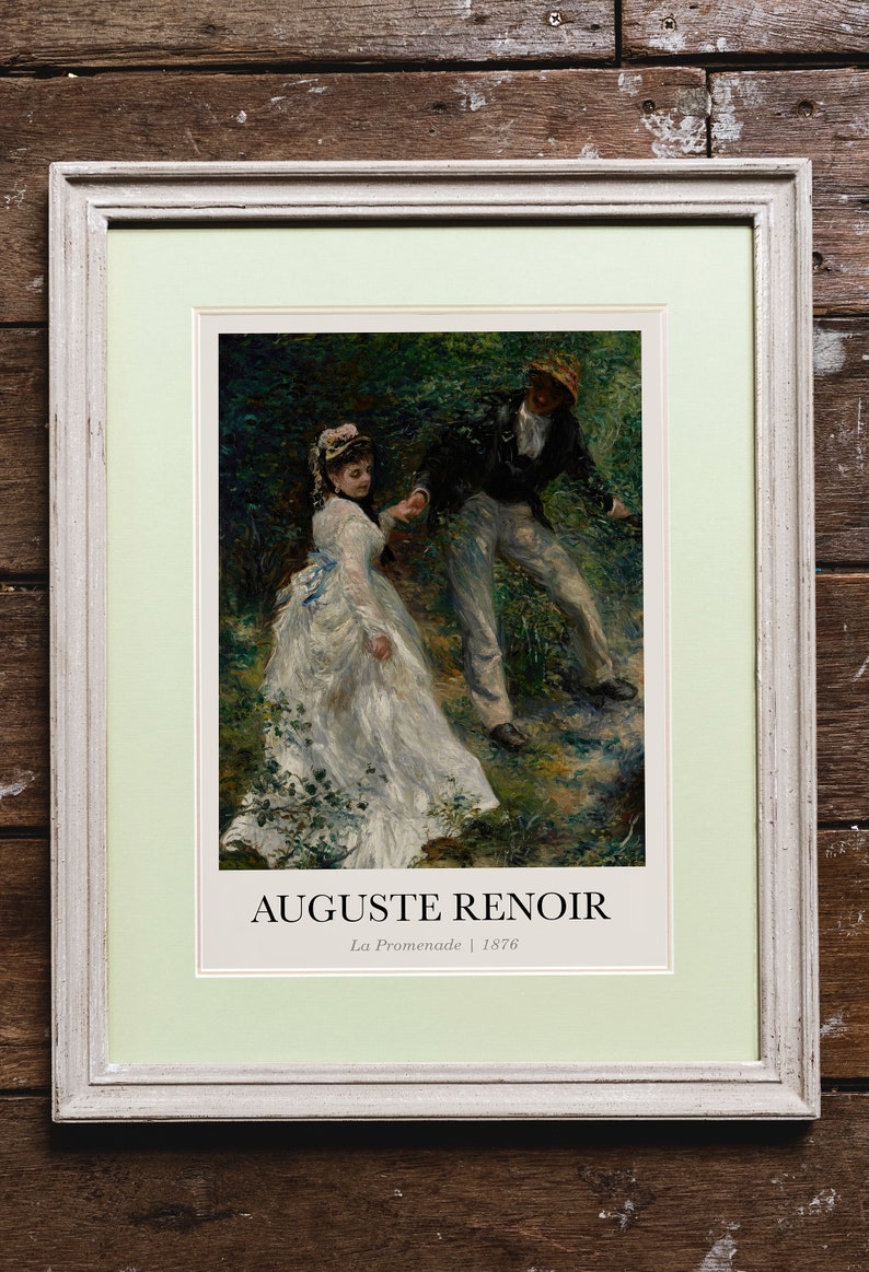 May include: A framed print of a painting by Auguste Renoir titled "La Promenade" from 1876. The painting depicts a couple walking through a wooded area. The woman is wearing a white dress and the man is wearing a dark jacket and light pants.