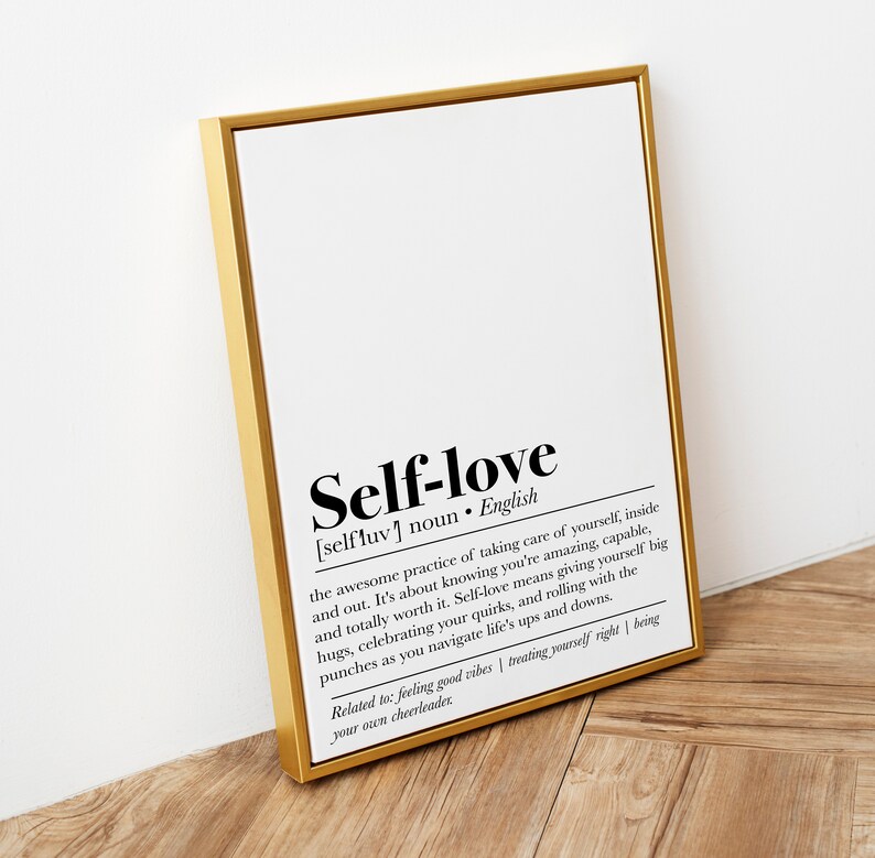 A golden-framed print on self-love, leaning against a wall, serves as a beautiful, affirming statement piece for any space that cherishes personal well-being.