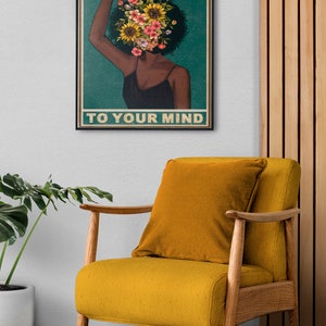 Framed poster with "Be Kind to Your Mind" text on a soothing yellow gradient background, complemented by cozy furniture and natural elements, emphasizing self-care and mental well-being.