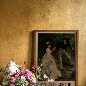 Reproduction of 'La Promenade' by Auguste Renoir, displayed next to a vase of flowers, with artist's name and year '1876' mentioned on the print