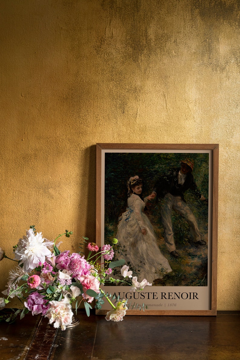 Reproduction of 'La Promenade' by Auguste Renoir, displayed next to a vase of flowers, with artist's name and year '1876' mentioned on the print