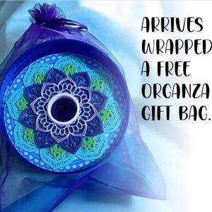May include: A blue and green mandala design in a round frame, wrapped in a blue organza gift bag. Arrives wrapped in a free organza gift bag.