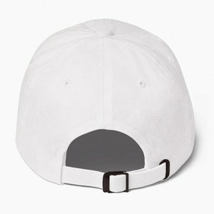 May include: A white baseball cap with a black adjustable strap in the back.