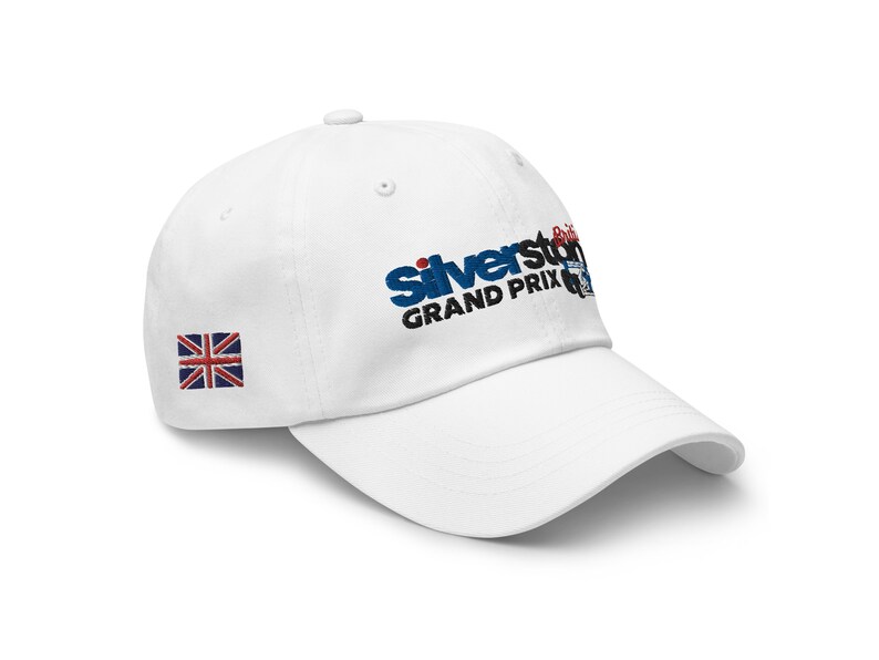 May include: White baseball cap with a blue and black embroidered logo that says "Silverstone Grand Prix" and a small Union Jack flag on the side.