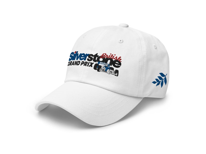 May include: White baseball cap with an embroidered logo that says "Silverstone British Grand Prix" with a small race car image. The cap has a blue and white leaf design on the side.