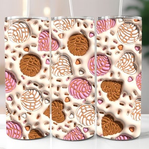 May include: Three stainless steel tumblers with a white background and colorful designs of Mexican pastries. The designs include pink, brown, and white pastries with sprinkles.
