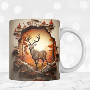 May include: White ceramic mug with a 3D design of a deer standing in a forest scene. The deer is brown with white markings and has large antlers. The forest scene is depicted in shades of brown, orange, and green.