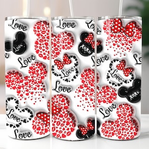 May include: White tumbler featuring a repeating pattern of red hearts, lips, and Minnie Mouse-inspired bows. Black Mickey Mouse silhouettes and the word "Love" are also present. The design includes the text "xoxo".