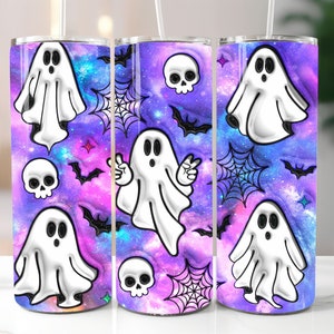 May include: A Halloween-themed tumbler featuring a vibrant purple and blue galaxy design. The tumbler is adorned with white cartoon ghosts, black bats, spiderwebs, and skulls. The design wraps around the entire tumbler, creating a festive and spooky aesthetic.