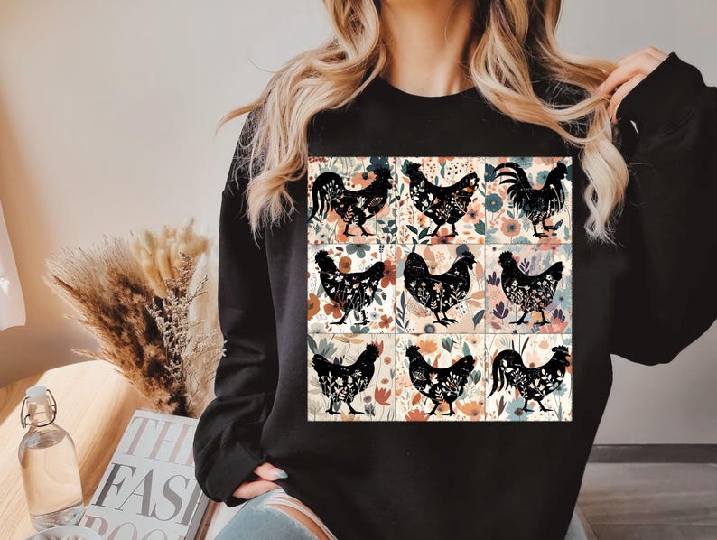 May include: Black sweatshirt featuring a nine-panel design with floral backgrounds and black chicken silhouettes. The chickens are in various poses. The sweatshirt is a solid black color.