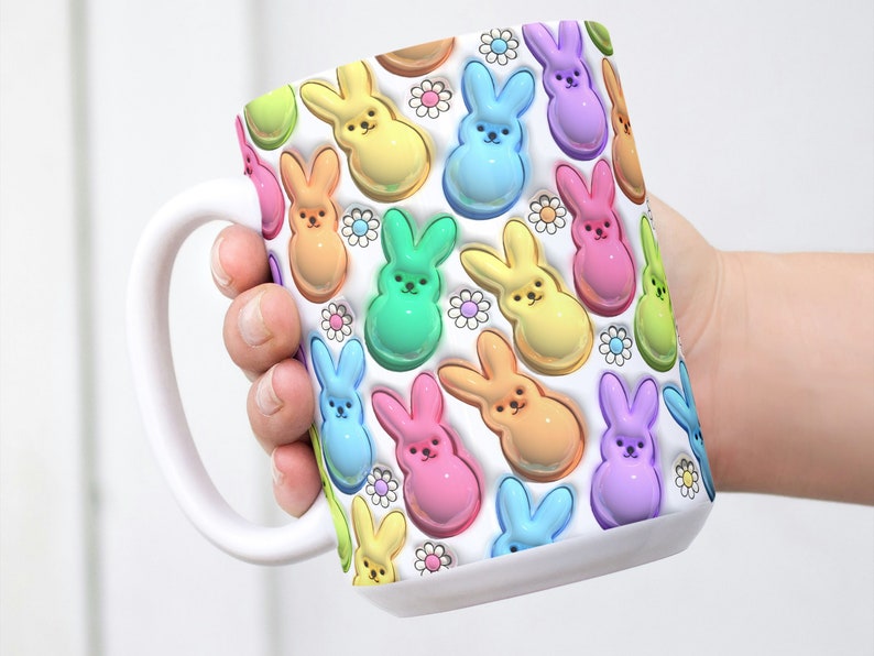 May include: White ceramic mug with a colorful pattern of pastel-colored bunny shapes. The bunnies are arranged in a repeating pattern and have a 3D effect.