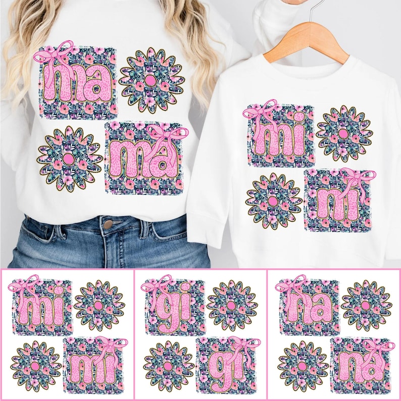 May include: Two white shirts with pink floral designs and the words "mama" and "mini" on them. The shirts are shown on a white background.