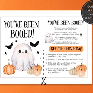May include: A printable Halloween "You've Been Booed" sign with instructions. The design features a cute ghost, pumpkins, bats, and stars. The text includes instructions on how to participate in the Halloween tradition.